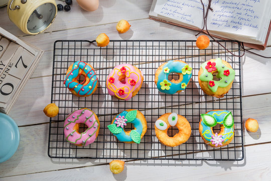 Decorating homemade donuts in the rustic kitchen