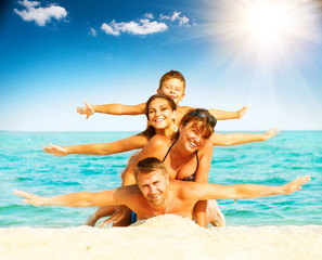 Fototapeta na wymiar Vacation. Happy family having fun at the beach