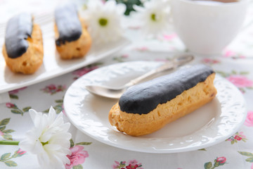 Eclairs with custard on white plate