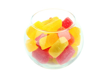 Colorful candies in glass bowl isolated on white