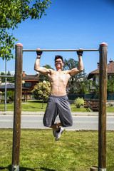 Fototapeta premium Attractive shirtless young man exercising outdoor in city park