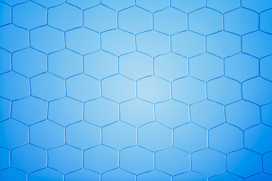Soccer goal net with blue background.