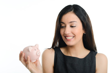 cheerful young brunette woman holding a piggy bank in hands