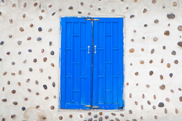 Blue wooden double door in a stone house