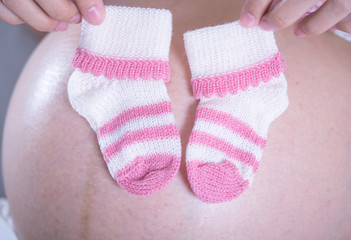 close up litle socks for Baby on Mather billy , pregnant women