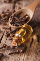 The essence of cloves in the bottle close-up. Vertical

