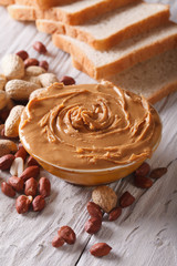 peanut butter in a bowl close-up on a table vertical
