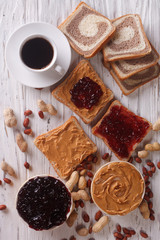 Sweet sandwiches with jelly, peanut butter and coffee top view
