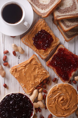 sandwiches with jam, peanut butter and coffee top view
