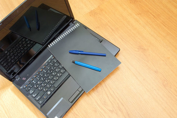 Computer notebook and pen on the table