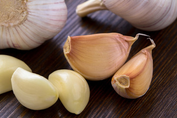 shelled garlic closeup on a dark wooden background