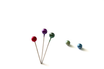 three pin stuck on a white background