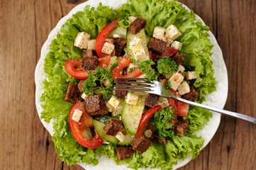 Vegetable salad made of lettuce, cucumbers, tomatoes, cheese and