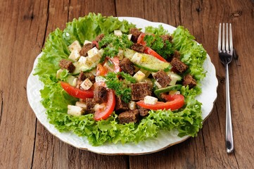 Vegetable salad made of lettuce, cucumbers, tomatoes, cheese and