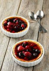 Fresh berry tarts on grey wooden background