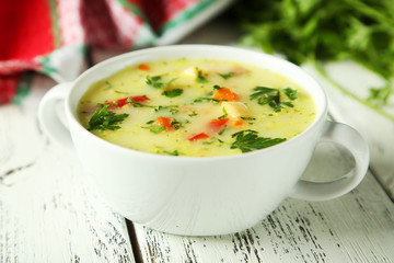 Bowl of soup on white wooden background