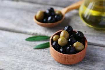 Foto op Plexiglas Green and black olives in bowl on grey wooden background © 5second