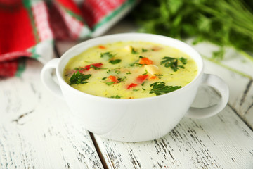 Bowl of soup on white wooden background