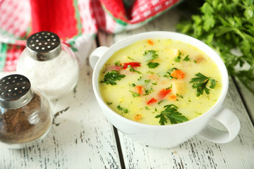 Bowl of soup on white wooden background