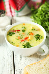 Bowl of soup on white wooden background