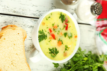 Bowl of soup on white wooden background