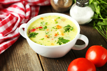 Bowl of soup on brown wooden background