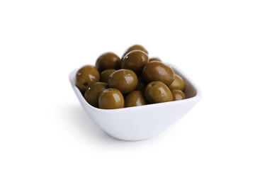 Green olives in bowl isolated on white