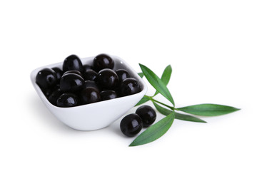 Black olives in bowl isolated on white
