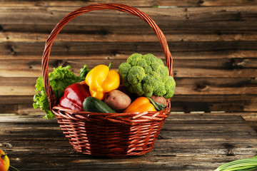 Vegetable in basket on brown wooden background