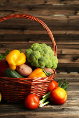 Vegetable in basket on brown wooden background