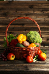 Vegetable in basket on brown wooden background