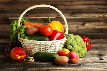 Vegetable in basket on brown wooden background
