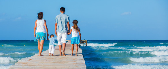 Family walking wooden jetty