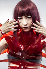 Japanese woman in costume of red plastic, modern and future conc