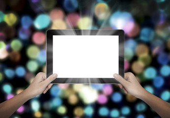 Female hand holding tablet pc on colorful bokeh background