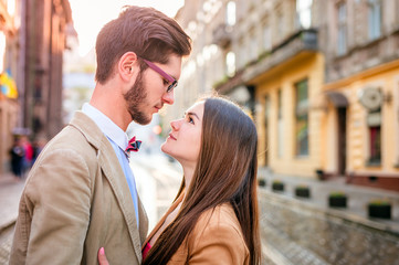 Young fashion elegant stylish couple posing on streets of europe