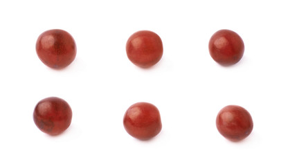 Six single dark red grapes isolated