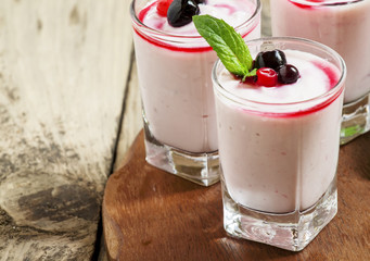 Homemade yogurt with berry juice and currants in a glass, select