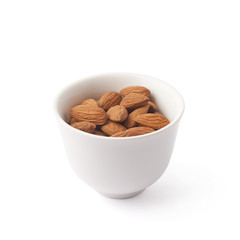 Cup full of almond seeds isolated