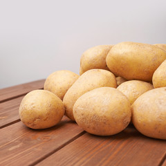 Pile of potatoes over the wooden surface