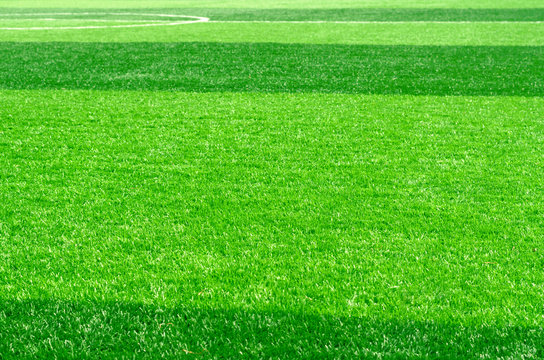 white stripe on artificial green grass of soccer field