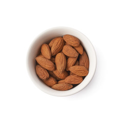 Cup full of almond seeds isolated