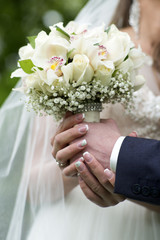 Obraz na płótnie Canvas Engaged couple holding a delicate bouquet