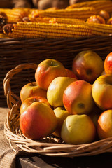 Apple and corn in basket on market