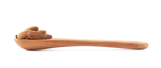 Spoon full of almond seeds isolated