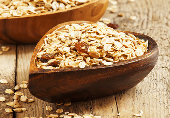 Homemade muesli in a bowl in the shape of a heart on a wooden ta