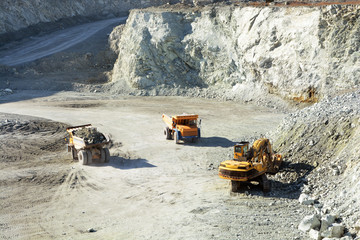 big yellow trucks in quarry - 83365603