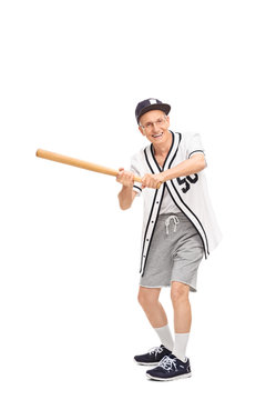 Senior man swinging a baseball bat