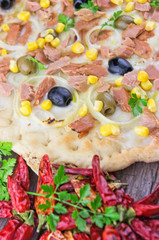 Pizza with corn, tuna, onions , olives