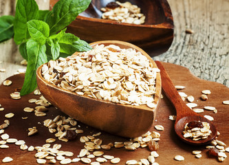 Homemade muesli in a bowl in the shape of a heart on a wooden ta